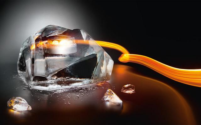 Block of ice with a glowing core, wrapped in an orange light trail against a dark background