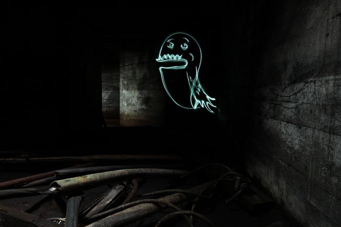 Ghost drawn in light in a dark, dilapidated room