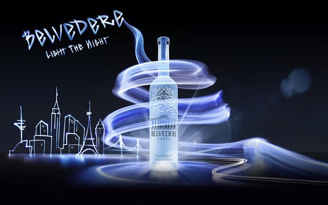 Vodka bottle with a light spiral and a drawn skyline, with the words “Belvedere Light the Night”