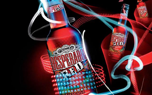 Red beer bottle with light trails and the glowing word “Red” against a black background