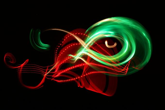 Red and green light trails woven into abstract shapes