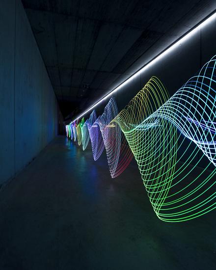 Tunnel with colourful light spirals in green, blue and red